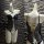 Glowing cloud sexy open-crotch leather bodysuit featuring cross-tie lace design and bell charm, perfect for women seeking ele...