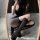 Sexy black fishnet stockings with thigh-highs, lace-up design, sheer texture, edgy and daring look.