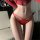 Elegant red lace thong briefs featuring sheer cutouts and bondage-style ties, perfect for women seeking stylish and sexy unde...