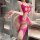 Woman wearing hot pink night si ye se sheer mesh bodysuit with bow details and open-crotch design in a modern bathroom.