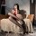A woman poses on a couch wearing yeqingges sexy lace-trimmed black thigh-high stockings, showcasing their sheer design and el...