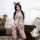 Woman in adorable bear maid costume set with plush lingerie, lace details, and thigh-high stockings for playful sleepwear.