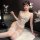 Woman modeling white lace ai ru ru lingerie set with garter belt, sheer stockings, and floral hair accessory.