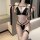 Woman modeling black ai ru ru sexy lingerie set with bondage-style straps and garter, passionate erotic costume outfit.