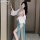 A woman poses in an alluring hanfu-inspired lingerie set, featuring sheer fabrics and elegant designs, perfect for seductive ...