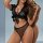Woman modeling black sheer lace lingerie set with open front bra and mesh panty, flirty and feminine style.