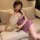 A woman lounges on a couch wearing an elegant ancient chinese style butterfly lovers sheer cheongsam set, featuring a sexy la...