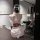 A woman sits facing away from the camera, wearing an elegant ancient chinese hanfu robe set inspired by the qin-han dynasty. ...