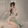 A woman poses with a smartphone, wearing an elegant ancient chinese style silk belly band bodysuit paired with a floral skirt...