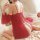 A woman wears a red ancient peony flowing sleeve set, featuring delicate lace details and flowing fabric, perfect for a luxur...
