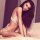 Woman wearing beautiful sexy lace thong set, elegant sheer sleepwear for women at home.