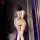 Woman in beige bird moon lace sheer lingerie set with tight bodycon skirt and lace stockings, back view.