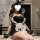 Woman in black lace bunny maid costume with white apron, fishnet stockings, and gloves, posing indoors.