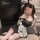 Woman in black lace bunny maid costume with fishnet stockings, posing seductively for nightclub role play.