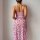 Pink lace dress with black heart pattern, featuring a delicate design and spaghetti straps, perfect for feminine elegance.