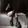 Black over-the-knee fishnet stockings featuring lace-up design and bow accents, perfect for edgy yet sweet looks.