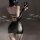 Sexy black patent leather corset dress with open back and sleeve details, perfect for nightclub and party outfits.