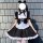 A woman models a black and white gothic lolita maid dress with puffy sleeves, ruffled skirt, and mouse ears headband, perfect...