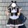 A woman wears a black and white gothic lolita maid dress with pigtails, perfect for halloween costumes.