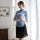 A woman elegantly poses in a blue lace cheongsam, featuring a sheer silk blend design, perfect for vintage-inspired roleplay ...