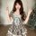A charming woman wears a vintage-inspired dress featuring a plaid pattern, lace-up waist, and ruffled skirt, perfect for summ...