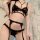 Black lace lingerie set with bralette, thong, and garter straps for a seductive look.