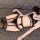 Woman wearing black lace lingerie set with garter straps on gray bed - bundled temptation sexy thong & bralette outfit