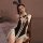 Woman wearing black bunny girl lingerie bodysuit with white lace, bow ties, and bunny ears—sexy open-crotch costume for adult...