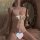 Woman wearing butterfly bow lace bodysuit set for small bust, featuring sheer lace and satin bow detail in romantic bedroom s...