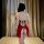 Woman wearing red butterfly embroidery lingerie set, vintage qipao-style sleepwear with open back and side slits.