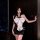 Woman modeling butterfly rain lingerie set: black bodycon skirt, reversible crop top with oversized white bow.