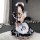 A person wearing a black and white maid costume with paw prints, taking a mirror selfie. the outfit features ruffles and bows...