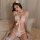 Woman wearing pink cat-themed lingerie set with fluffy bra, bow, and open-crotch panties, paired with fishnet stockings and b...
