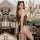 Woman wearing hot cat-themed sexy lingerie bodysuit – black fishnet mesh one-piece with leopard print accents and cat ears, p...