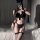 A woman poses in a black catwoman-themed lingerie set featuring a bow top, fishnet stockings, and garter straps, perfect for ...