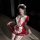 A woman poses in a maid-themed outfit featuring a red and white dress with lace details, perfect for cosplay or adult enterta...