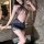 Woman wearing chao mu sexy lace halter bodycon dress with sheer mesh and lace details in a bathroom setting.