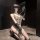 Woman kneeling in chao mu sexy lingerie bodysuit with embroidered sheer fabric, open-cup and open-crotch design, paired with ...