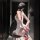 Woman in chao mu sexy secretary costume set with bodycon mini skirt, posing seductively on a chair.