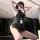 Woman in chao mu sexy secretary costume set with bodycon mini skirt, posing seductively indoors.