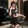 A stylish woman poses confidently wearing a chic black jk-style outfit featuring a pleated skirt and matching bra, perfect fo...