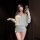 Woman wearing chaomu sensual lingerie dress - one-shoulder backless cutout bodycon mini dress in soft gray, posing with lace ...