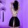 Woman wearing black chaomu sensual lingerie set with open back and sheer skirt, posing in purple-lit room with decorative fan...