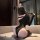 Woman in black chaomu temptation lace bodysuit, off-shoulder design, kneeling on sofa with bunny ears.