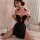 A woman poses wearing a black cherry blossom embroidered lingerie set, featuring a backless vintage qipao design with a high ...
