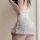 Woman wearing a white floral lace cami dress with purple lilac trim, part of the cherry blossom romance lingerie set.