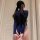 Woman wearing navy blue cherry blossom romance lingerie set, featuring a three-piece bikini bra and panty ensemble with white...
