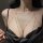 Woman wearing cherry blossom body chain with crystals, a sexy lingerie accessory featuring delicate gold chains and sparkling...