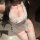 Woman wearing a cherry lace maid costume with a backless apron, cheeky cut-outs, and sheer trim.