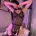 Woman wearing cherry love sheer mesh backless high-waist bodysuit with lace trim, posing in pink-lit room.